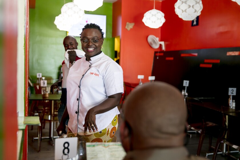 LOS ANGELES, CALIFORNIA - July 18, 2019: (C) Àdùké, chef owner of Aduke African Cuisine, talks with a customer on Thursday, July 18, 2019, outside of her Nigerian restaurant in Midcity. (Silvia Razgova / For The Times) Assignment ID: 459577